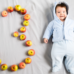 A young baby with the number three spelled out in apples. Assisted Reproductive Technology Law